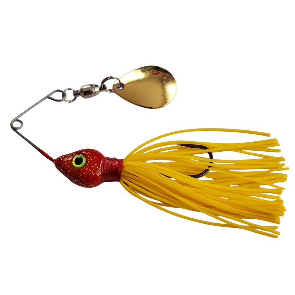 Fishing lure with red body, yellow skirt, and gold blade on a white background